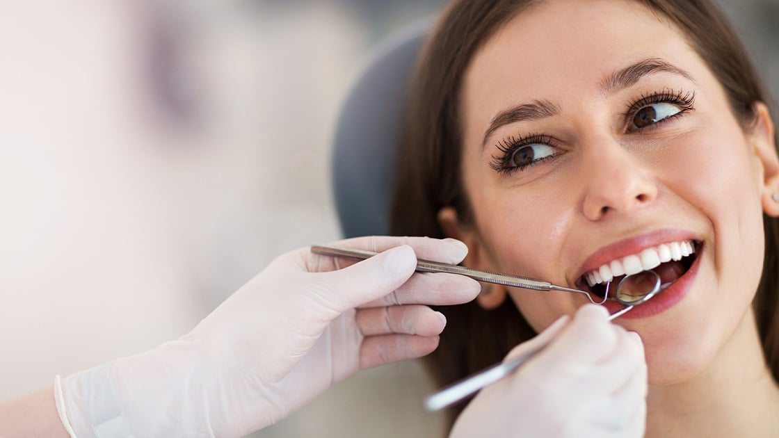 Lady With Brown Hair In Dental Procedure